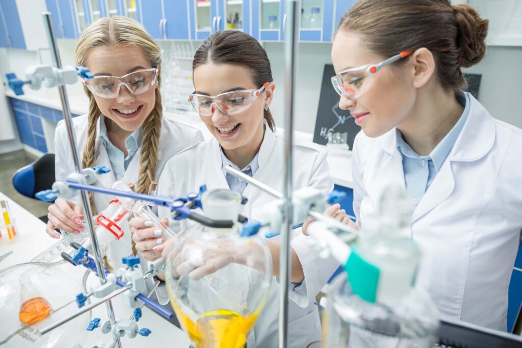 smiling-female-scientists-in-protective-eyewear-ma-2022-12-16-19-30-47-utc-min-1024x683